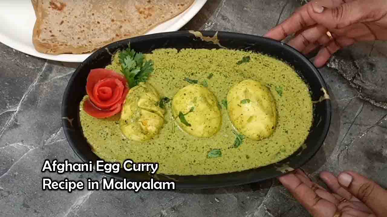 A plate of delicious Afghani Egg Curry garnished with fresh coriander leaves, served with naan and rice, prepared using a traditional Malayalam recipe.